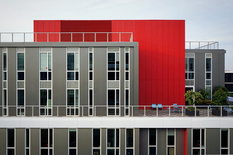 image of a modern building with red stucco
