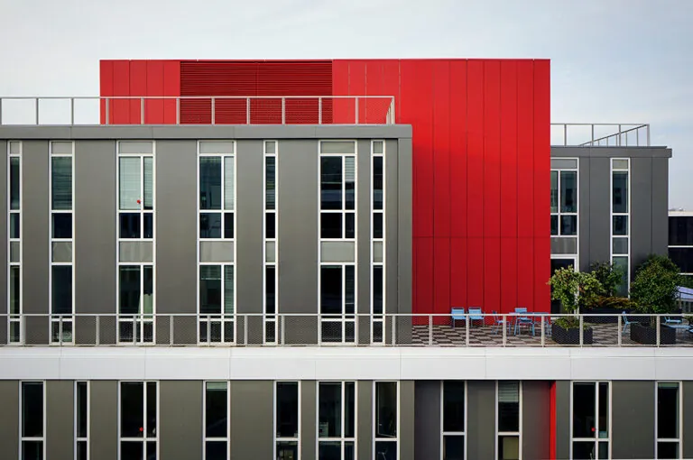 image of a modern building with red stucco