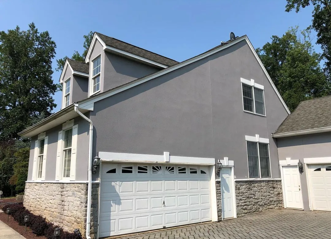 Morganwille NJ 7 Freshly restored stucco siding on a residential home in Morganville New Jersey after expert moisture repair work