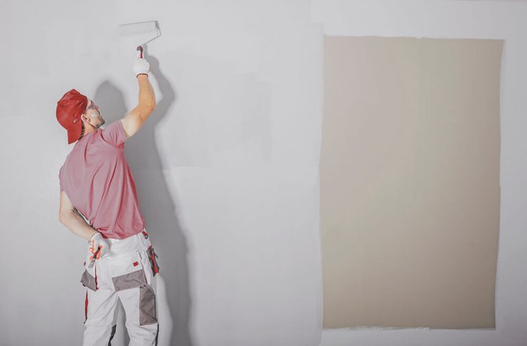 man is painting the wall
