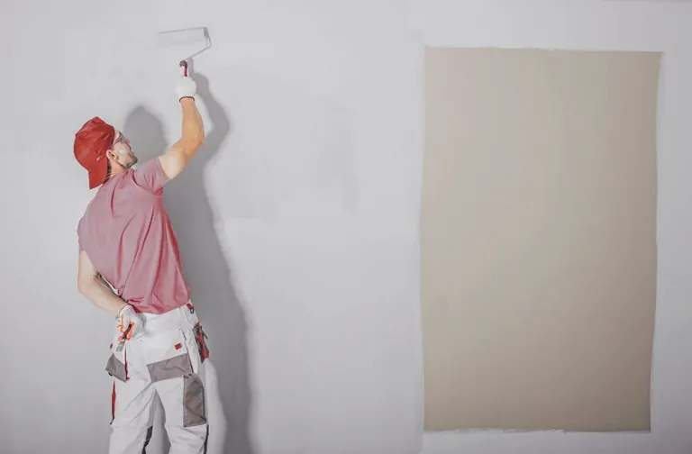 man is painting the wall