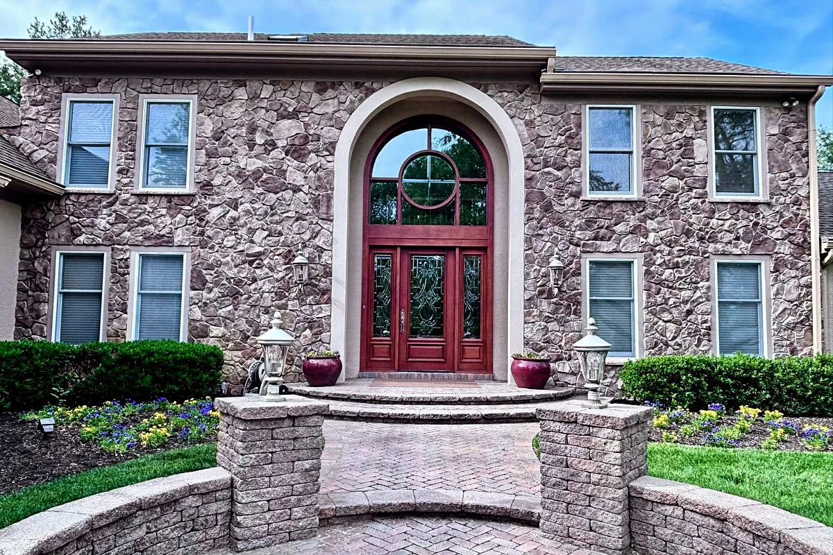 Entryway and front wall detail of Moorestown home showing restored stucco texture and architectural elements