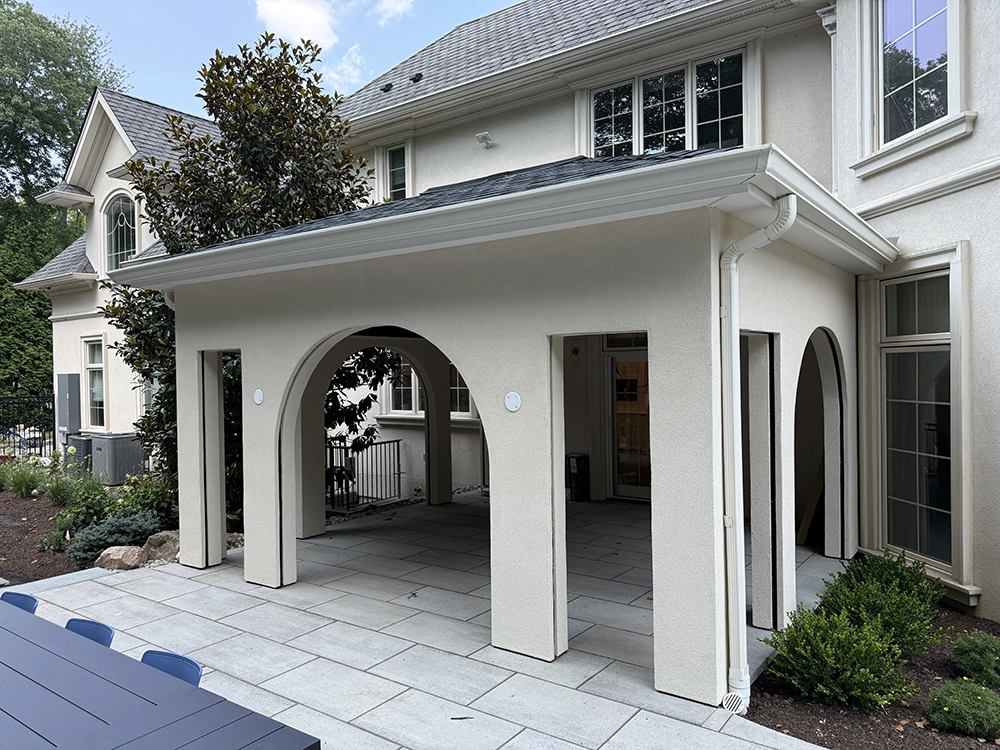 Backyard pavilion with multiple arches finished in uniform stucco; project by ZD Stucco Repair in Demarest, NJ.