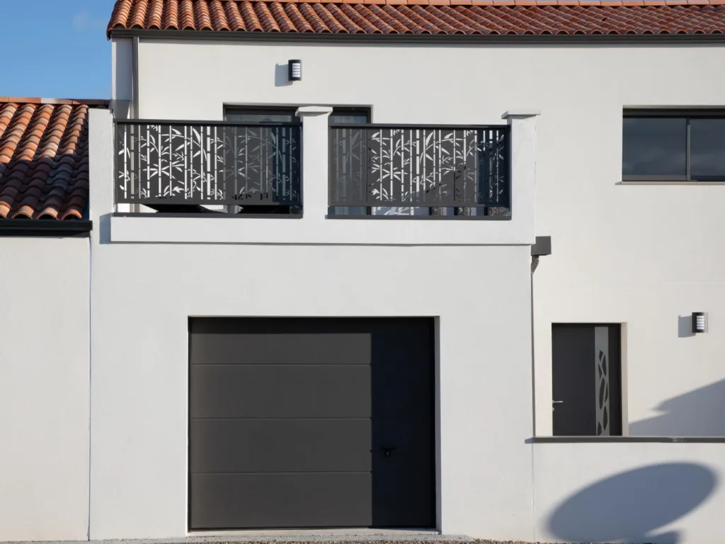 Prices of Stucco Repair and Installation in New Jersey in 2025 4 Modern white stucco home with decorative balcony, dark garage door and terracotta tile roof in New Jersey