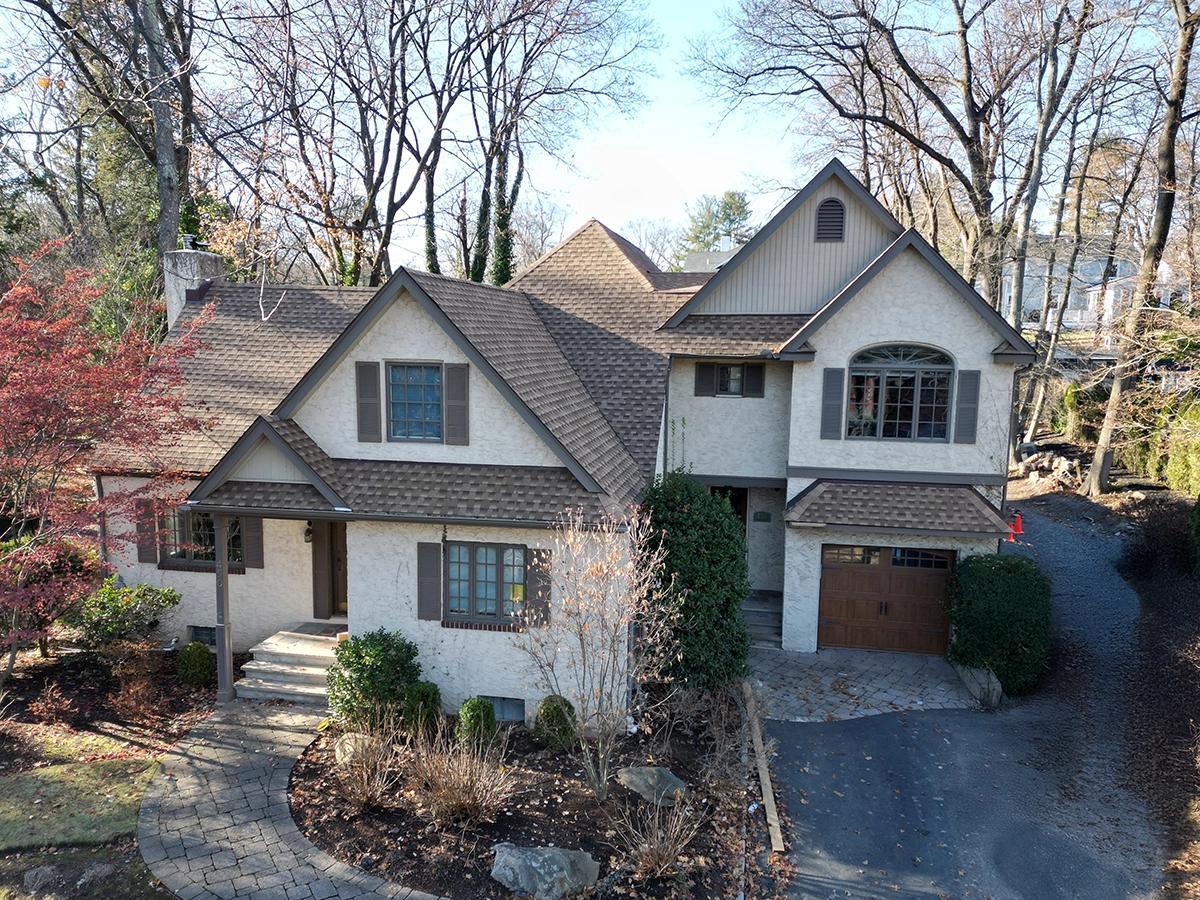 Stucco Repair and Installation in Ridgewood, NJ 4 Front aerial of a two-story stucco house in Ridgewood, New Jersey with fresh facade after professional repair