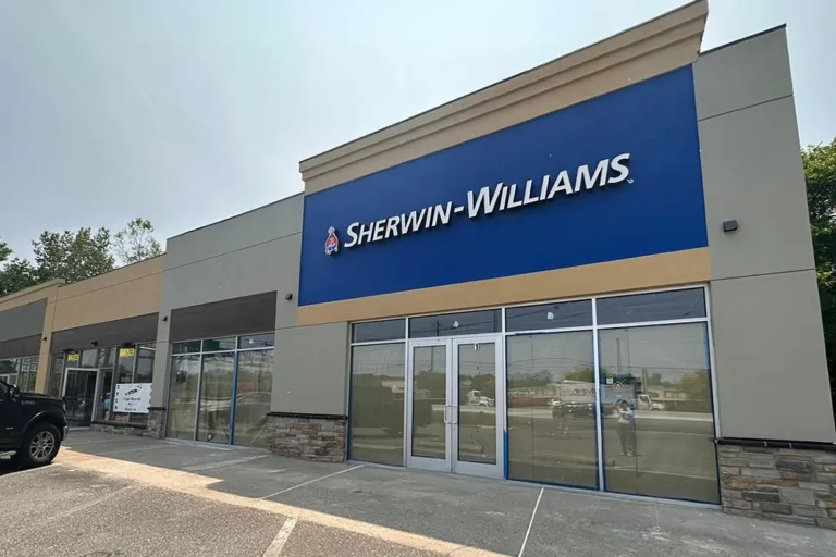 Updated retail plaza facade with new EIFS bands and signage at a Sherwin-Williams store.