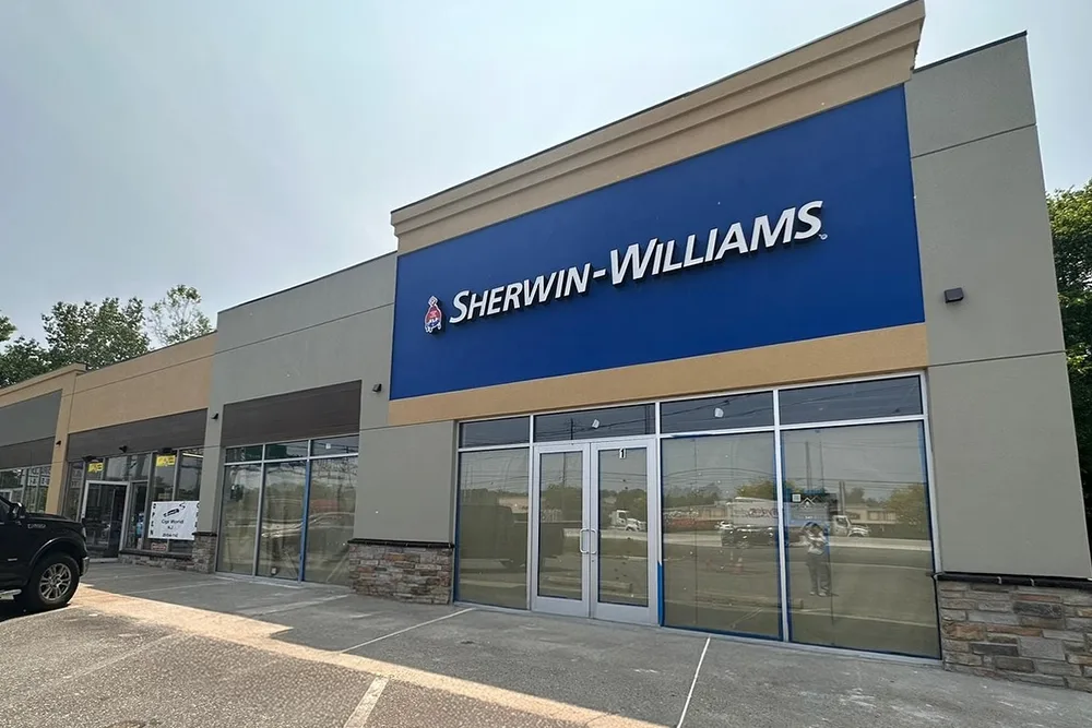 Updated retail plaza facade with new EIFS bands and signage at a Sherwin-Williams store.