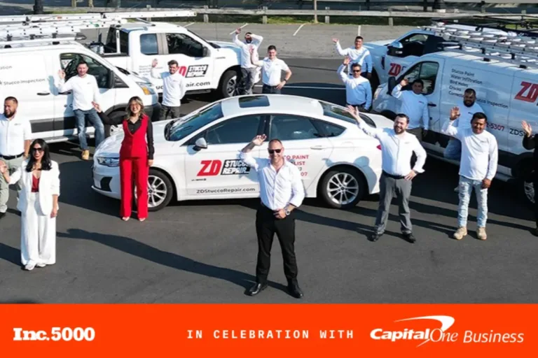 ZD Stucco Repair team standing with company vehicles waving in celebration of their Inc. 5000 recognition