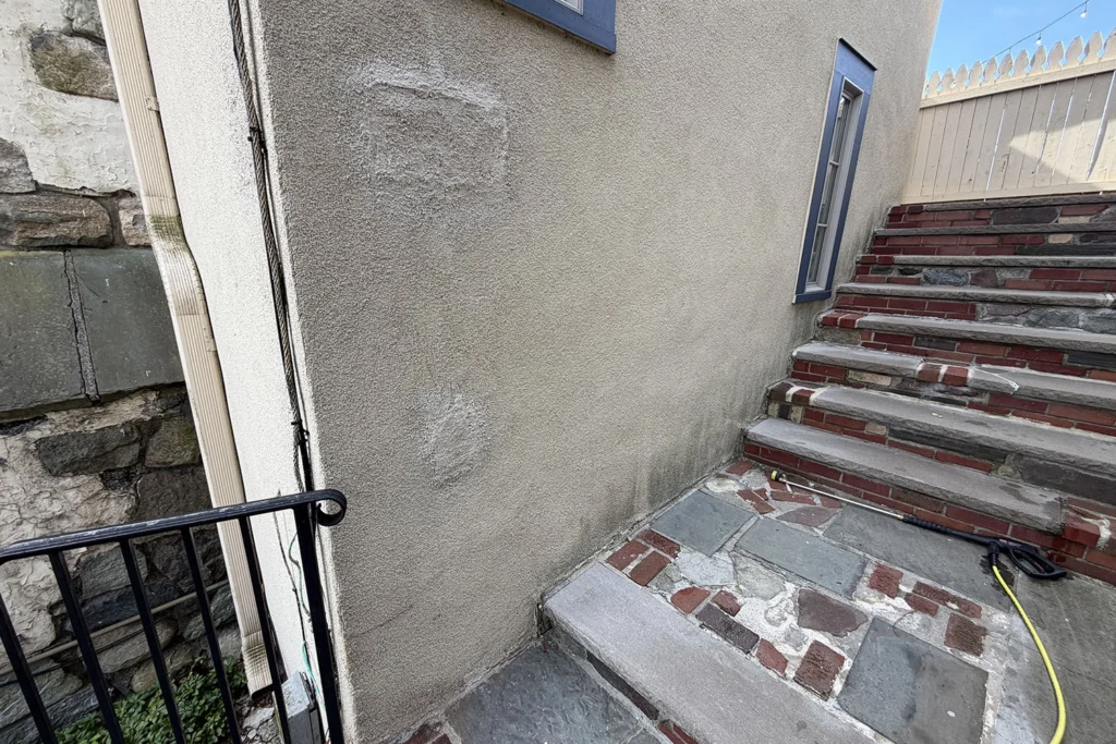 How We Restored a Historic 1930 Castle to Its Original Glory: Lake Mohawk Country Club Stucco Restoration 3 Damaged stucco wall and stairs before restoration work on the historic Lake Mohawk Country Club building