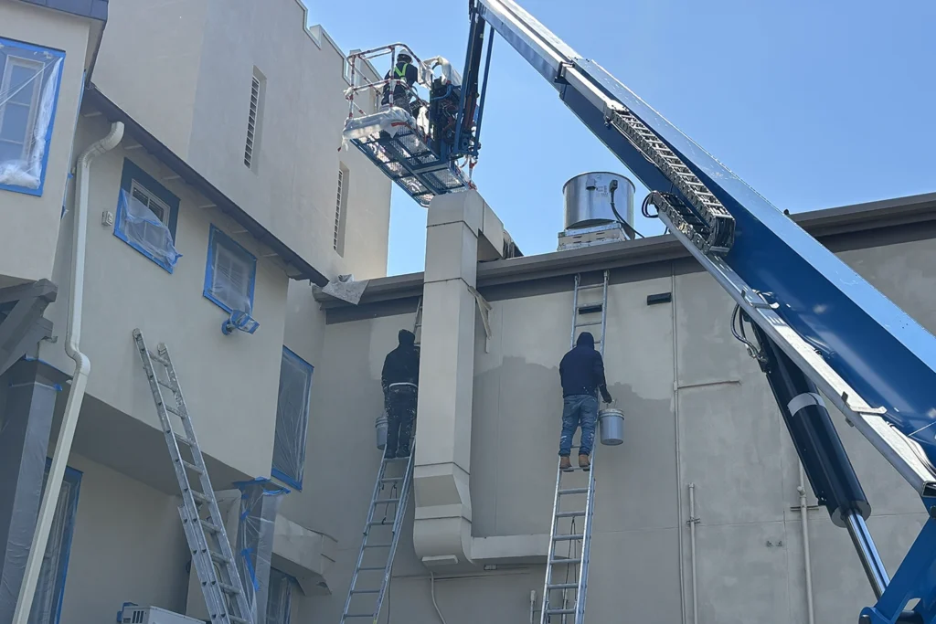 How We Restored a Historic 1930 Castle to Its Original Glory: Lake Mohawk Country Club Stucco Restoration 6 ZD Stucco Repair crew restoring upper stucco sections of the historic Lake Mohawk Country Club building using lift equipment