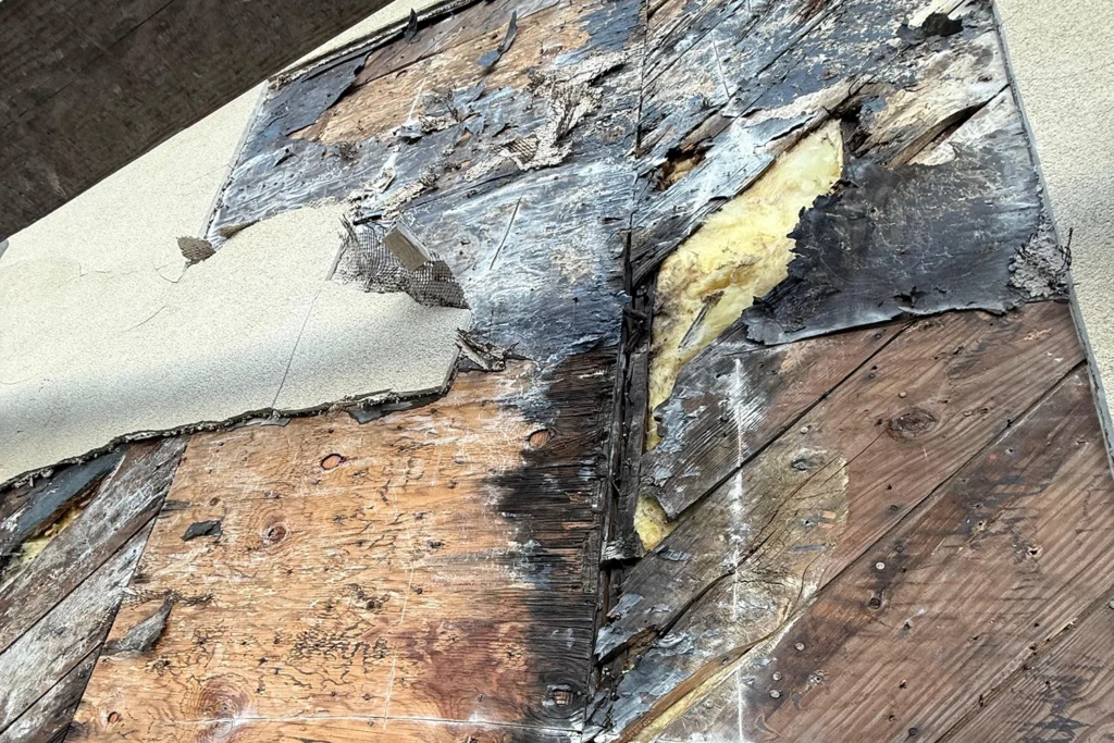 How We Restored a Historic 1930 Castle to Its Original Glory: Lake Mohawk Country Club Stucco Restoration 5 Exposed water-damaged wood sheathing behind failed historic stucco during Lake Mohawk Country Club restoration in Sparta, NJ