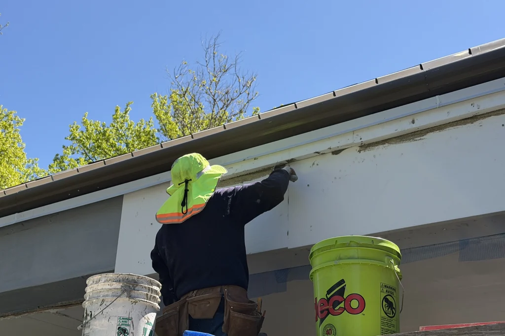 EIFS Synthetic Stucco Problems & Solutions in New Jersey 8 Professional stucco contractor applying base coat to exterior wall during commercial stucco repair project in New Jersey
