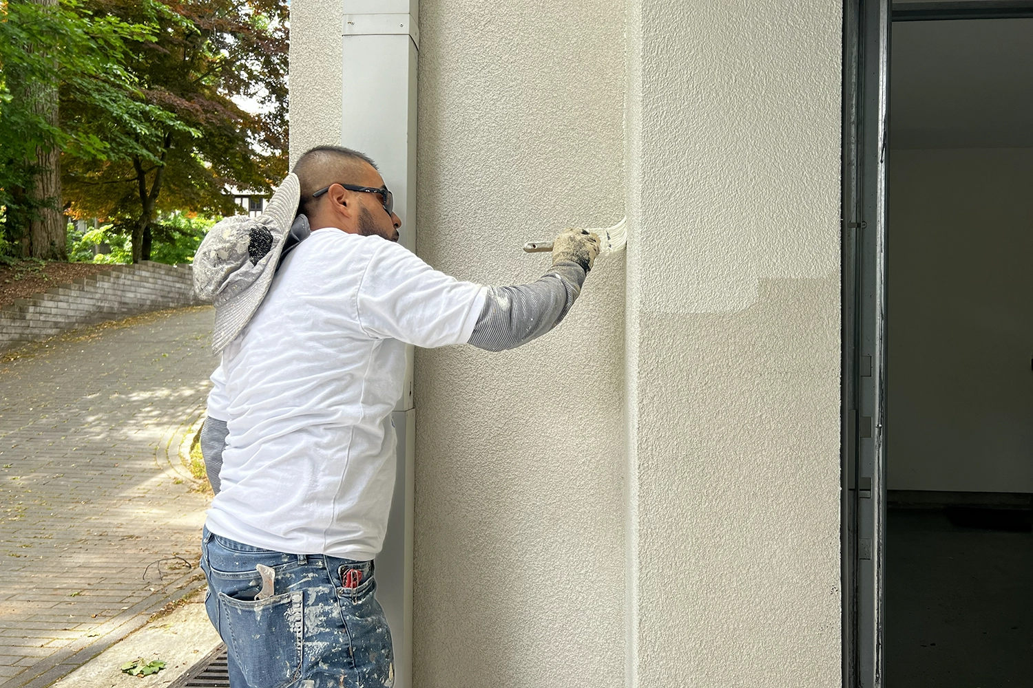 Contractor matching texture and color after exterior wall repair