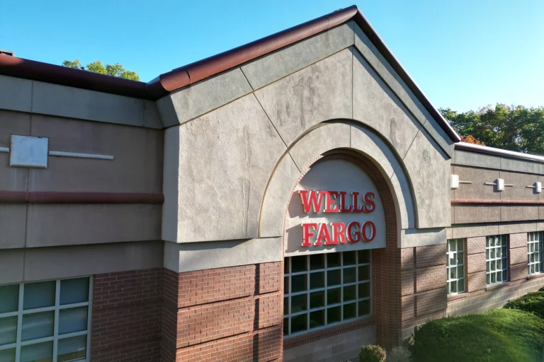 Completed commercial stucco restoration on Wells Fargo building featuring gray and red stucco facade with proper flashing and architectural details in Clifton, NJ