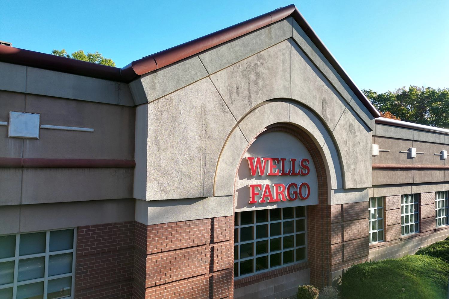 Completed commercial stucco restoration on Wells Fargo building featuring gray and red stucco facade with proper flashing and architectural details in Clifton, NJ