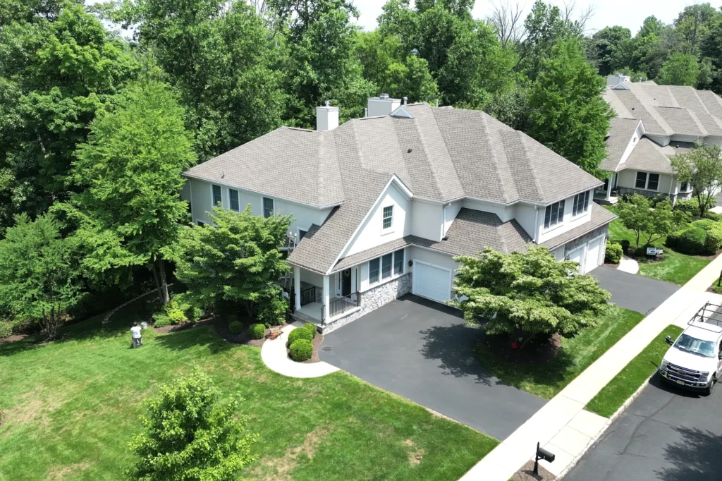 Complete aerial view of the stucco home exterior and driveway in Basking Ridge, NJ.