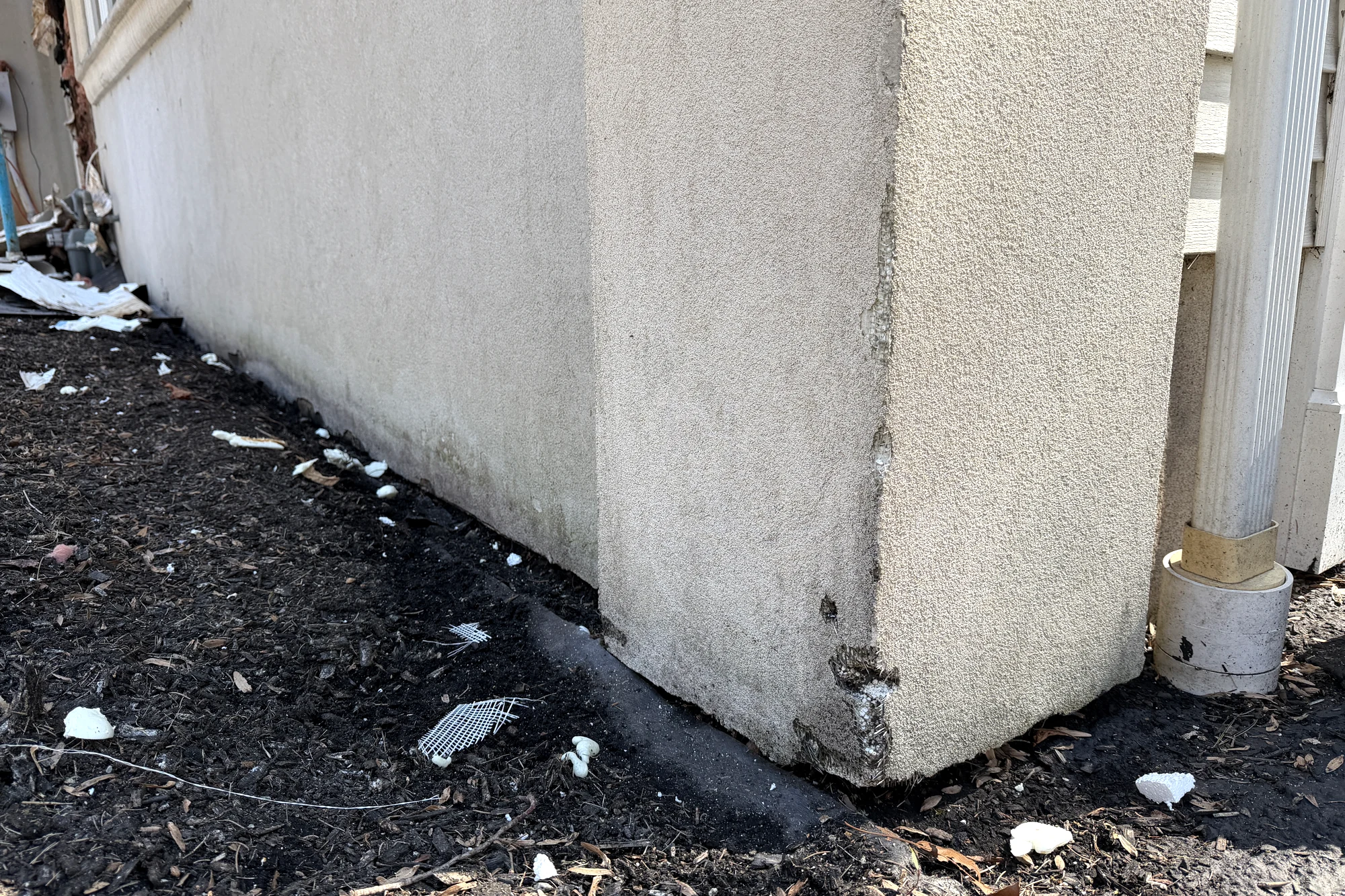 Downspout corner moisture damage before at Franklin Lakes residence in Franklin Lakes, NJ.