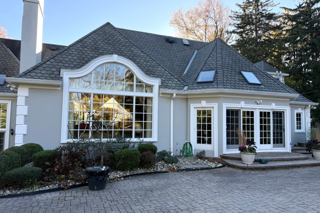 15 Gray Stucco House Ideas: Light, Dark, White Trim & Black Accents 3 Restored rear glazed facade and patio elevation at a Saddle River residence in Saddle River, NJ.