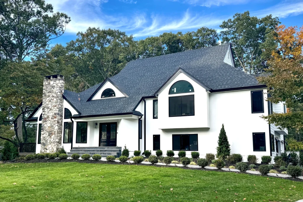 15 White Stucco House Ideas: Black Trim, Windows, Stone & Modern Designs 3 Restored front facade at Upper Saddle River residence in Upper Saddle River, NJ.