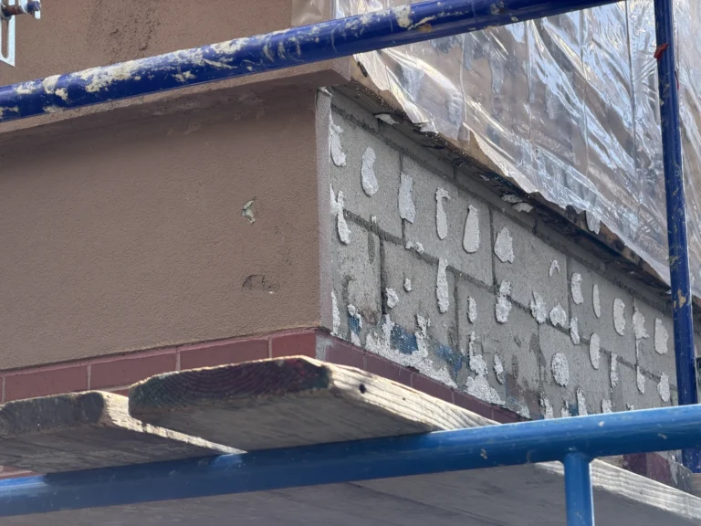 Partially removed EIFS cladding with exposed backing at the Wells Fargo project.