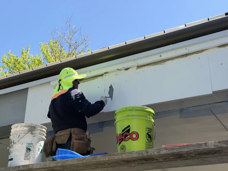 EIFS technician using a trowel on the exterior fascia at the Wells Fargo project.
