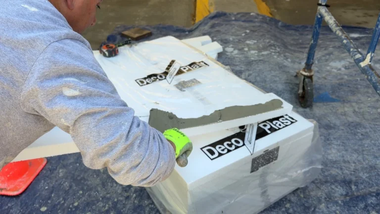 Technician applying adhesive to an EPS foam piece before installation at the Wells Fargo project.